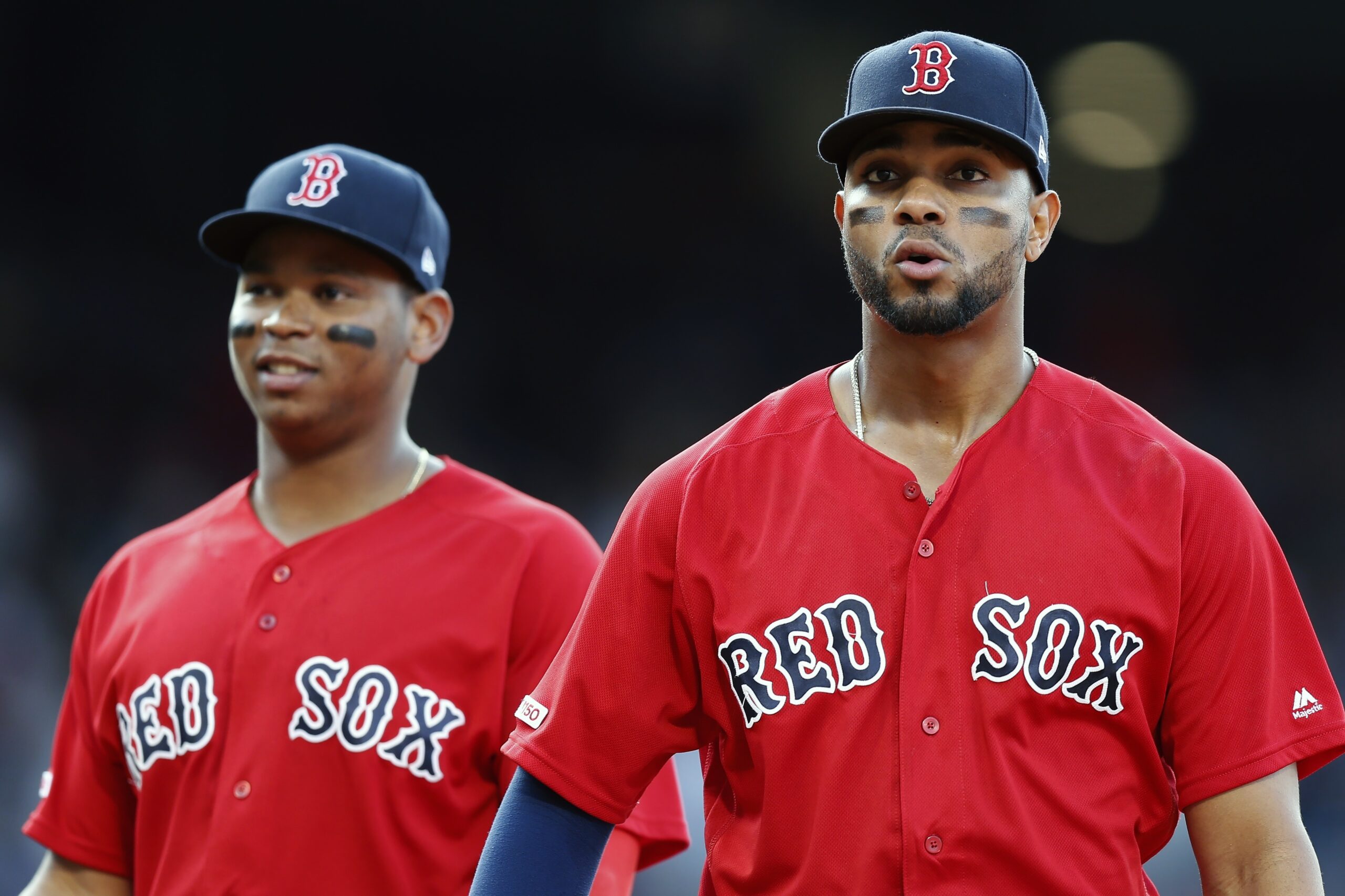 Boston Red Sox's Xander Bogaerts, right, and Rafael Devers come in at the top of the seventh inning of a baseball game against the New York Yankees in Boston, Saturday, July 27, 2019. (AP Photo/Michael Dwyer)