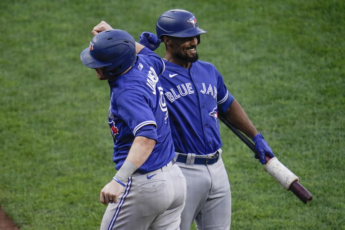 Toronto Blue Jays' Danny Jansen, left, is congratulated by Marcus Semien after hitting a two-run home run against the Baltimore Orioles during the fourth inning of the first game of a baseball doubleheader, Saturday, Sept. 11, 2021, in Baltimore. Julio Cortez - staff, AP