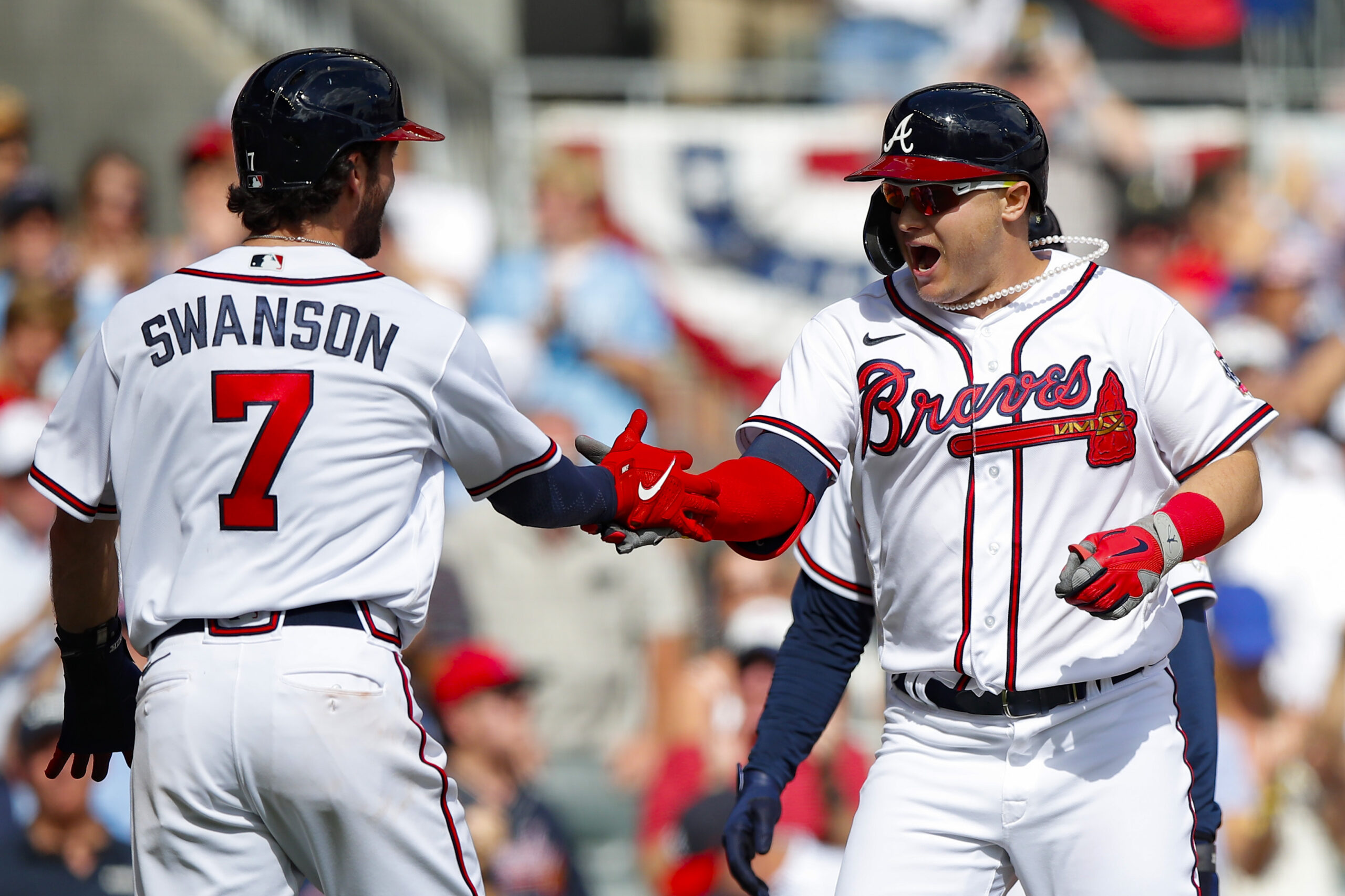 ATLANTA, GEORGIA - OCTOBER 11: Joc Pederson #22 of the Atlanta Braves high fives Dansby Swanson #7 after hitting a three run home during the fifth inning against the Milwaukee Brewers in game 3 of the National League Division Series at Truist Park on October 11, 2021 in Atlanta, Georgia. (Photo by Todd Kirkland/Getty Images)