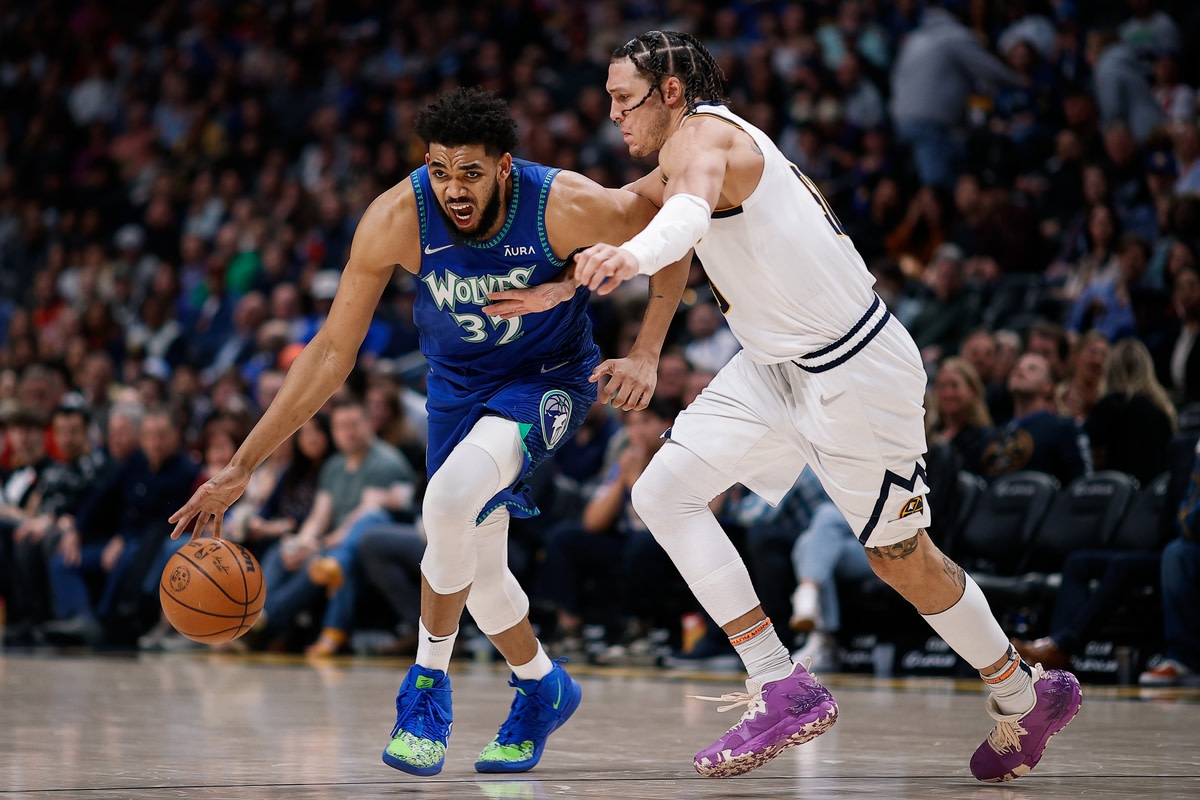 Apr 1, 2022; Denver, Colorado, USA; Minnesota Timberwolves center Karl-Anthony Towns (32) controls the ball as Denver Nuggets forward Aaron Gordon (50) guards in the fourth quarter at Ball Arena. Mandatory Credit: Isaiah J. Downing-USA TODAY Sports