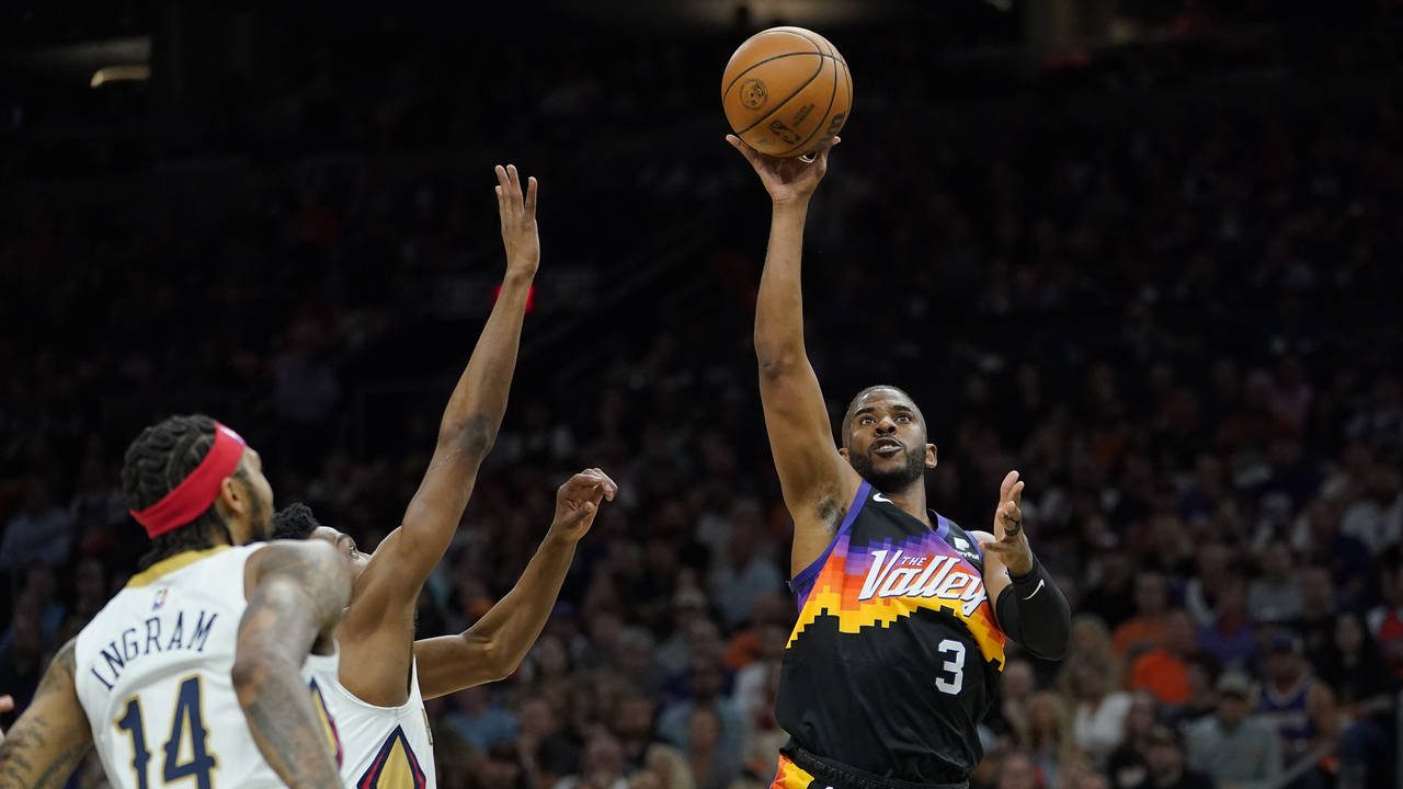 Phoenix Suns guard Chris Paul (3) passes next New Orleans Pelicans guard Devonte' Graham (4) in the second half of Game 4 of an NBA basketball first-round playoff series in New Orleans, Sunday, April 24, 2022. (AP Photo/Matthew Hinton)