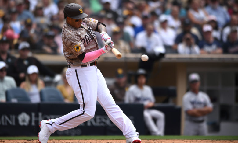 May 8, 2022; San Diego, California, USA; San Diego Padres third baseman Manny Machado (13) hits a single during the fifth inning against the Miami Marlins at Petco Park. Mandatory Credit: Orlando Ramirez-USA TODAY Sports