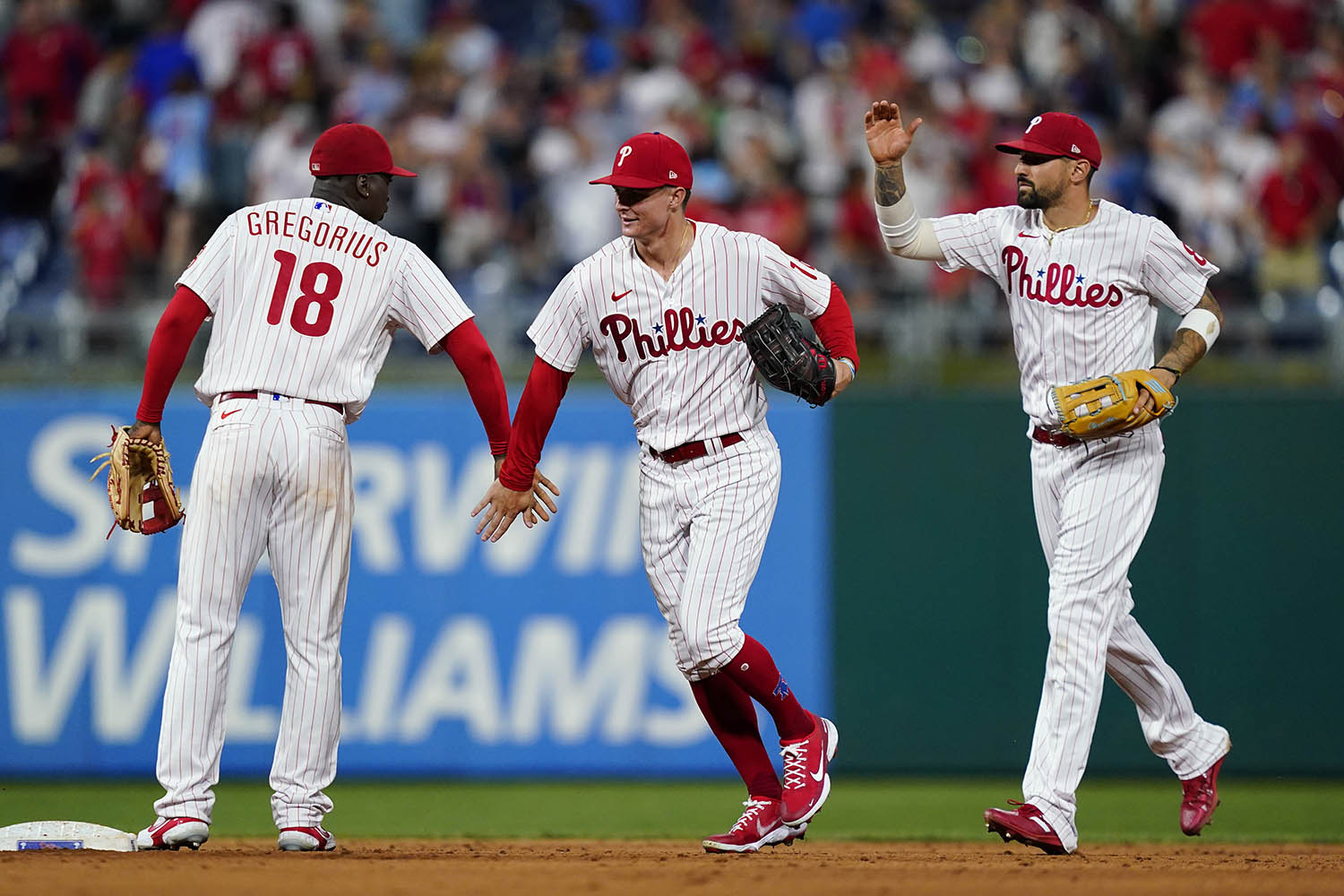 Philadelphia Phillies' Didi Gregorius, from left, Mickey Moniak, and Nick Castellanos celebrate after a baseball game against the St. Louis Cardinals, Friday, July 1, 2022, in Philadelphia. (AP Photo/Matt Slocum)