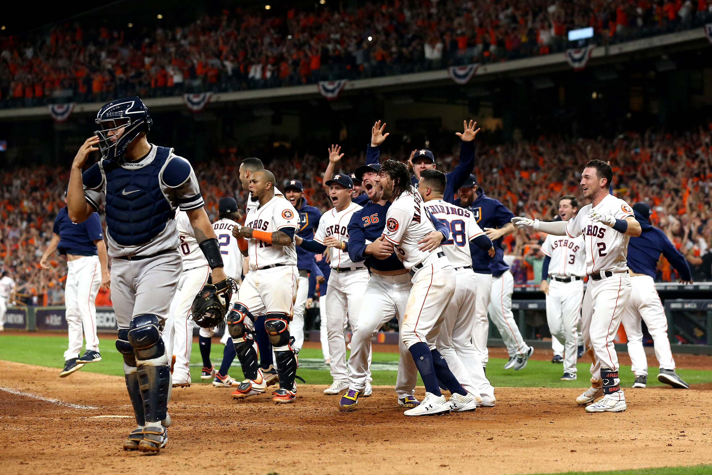 HOUSTON, TEXAS - OCTOBER 19:  The Houston Astros celebrate their 6-4 win against the New York Yankees on a ninth inning walk-off home run by Jose Altuve (not pictured) as Gary Sanchez walks off the field in game six of the American League Championship Series at Minute Maid Park on October 19, 2019 in Houston, Texas. (Photo by Bob Levey/Getty Images)