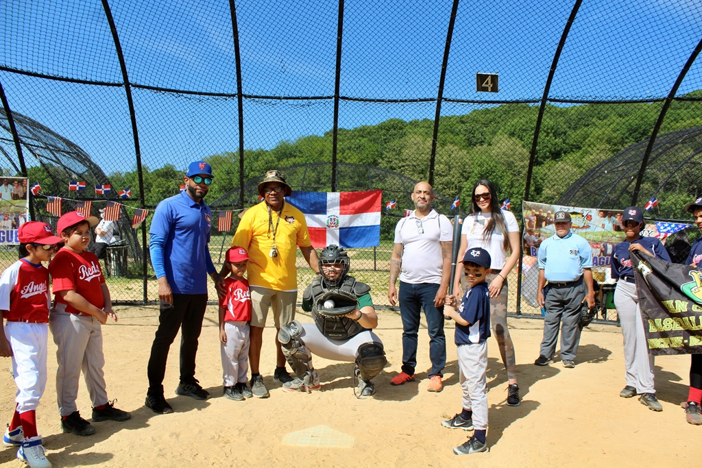El niño Hunter Almánzar, funge de bateador, mientras David Pozo, recibe y Mariano Almánzar, árbitro.
