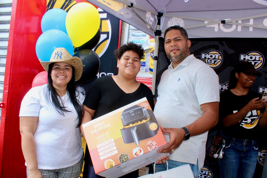 Aníbal Tejada y Marleny Gómez Medina, entregan al niño ganador un esperado premio para su abuelita.
