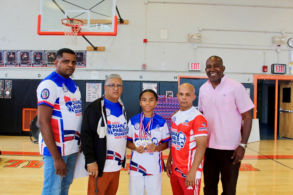 José Ortiz y Evaristo Madrigal, principales dirigentes de la Unión Deportiva Dominicana de Nueva York, y el maestro Bernardo Reynoso, al igual que el instructor Rubén Peña, acompañan a Elyan Bello, ganador de dos medallas de oro y el título de Gran Campeón.